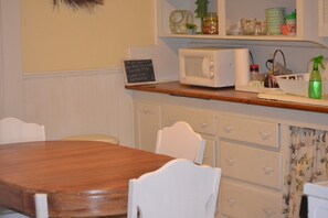 Dining Area in Kitchen with Microwave,  Stove, Refrigerator and Coffeemakers