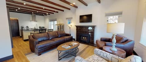 Beautiful tile fireplace and wood beams in living area