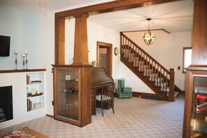 Spacious entry and living area, original woodwork throughout the house.