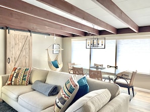 Living & dining room w/ocean views, chase couch, dining seats 6, corner swing.