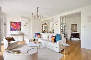 Comfortable living room and spiral steps to upper level.