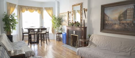 Living room has plenty of seating and decorative fireplace