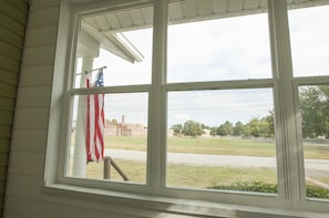 View from sun room overlooks green space.