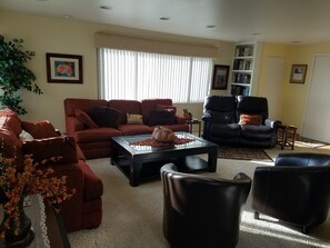 Living room from patio door with original artwork on walls