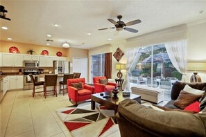 Kitchen and family room with plenty of natural light and pool views.