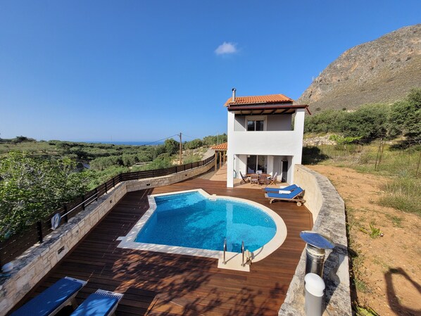 View of the villa showing private pool, sea view and mountain.  
