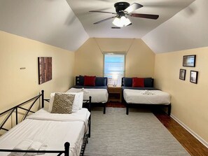Bedroom with two full beds and one twin