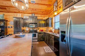 Custom kitchen w/ stainless steel appliances - HUGE island to entertain around.