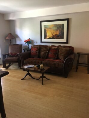 Comfy couch and hand crafted rocking chair, make for an inviting front room 