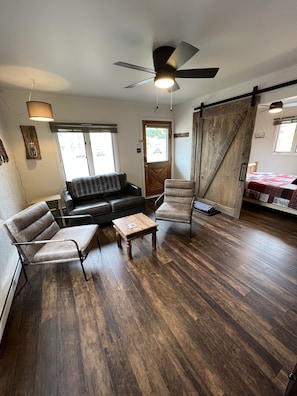 Living room with leather loveseat and comfortable chairs.