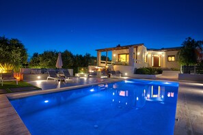 Night photo of the pool area.