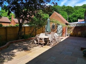 Private enclosed patio rear garden with dining table for 10 and charcoal BBQ