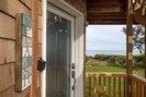 3 steps up to the covered front porch; views of the sea and Yoakam Point.