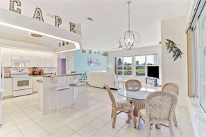 The back of the home is wide open with a spacious kitchen, eating nook, and family room - all with a stunning view of the water!