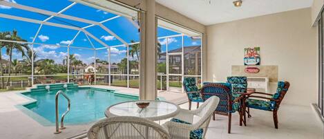 Enjoy your meals or morning coffee overlooking the pool and canal under the covered portion of the screened lanai.