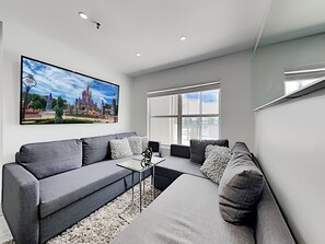 Relax in this comfy living room with sofa bed option plus 70-inch Smart TV.