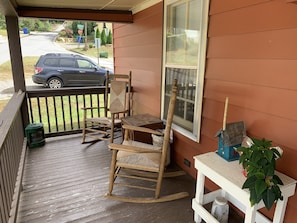 Rocking Chairs on One Side of Porch and Glider Couch on the Other