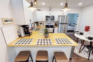 Bar with extra seating; kitchen with Keurig Coffee Maker
