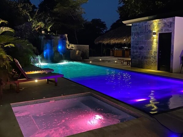 Tempered Jacuzzi, waterfall and slide in the background