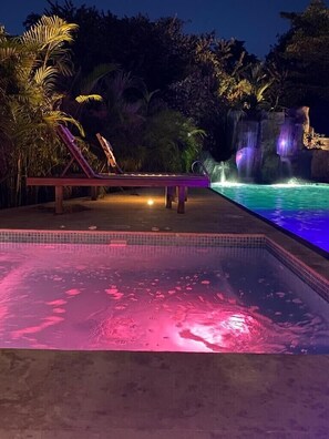 Tempered Jacuzzi for a chili/rainy night/ Waterfall and slide in the background