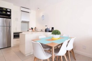 Dine inside at the six-seater timber table.