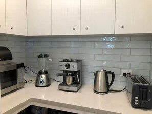 Kitchen pantry. Microwave, coffee machine, kettle, toaster, blender, rice cooker