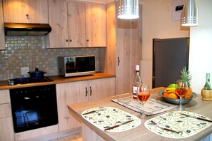 Fully kitted kitchen includes fridge, stove, washing machine, microwave etc