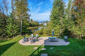 Back patio with fire pit, grill and lake views!