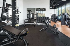 A well-equipped fitness center with modern workout machines and ample space for exercises.