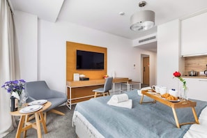 A living space featuring a television, small furniture, and bright decor for a welcoming ambiance.