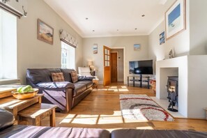 Westgate Cottage, Thornham: Cosy sitting room with wood burning stove