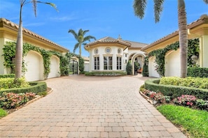 Front of the house with 4 garages and a gated entry