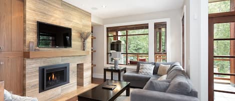 Living area with sectional sofa and mountain views