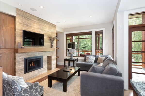 Living area with sectional sofa and mountain views