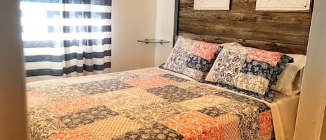 Master bedroom features a headboard made from barn board hewn 70 years ago.