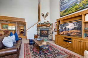 Living Room with Vaulted Ceilings, Smart TV, Gas Fireplace, and Leather Queen (Air Mattress) Sleeper Sofa