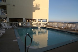 Condo complex pool that overlooks beach 