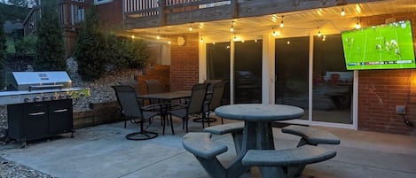 Outdoor patio with plenty of seating and and outdoor HDTV