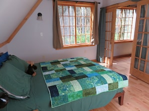 Queen size bed in bedroom.