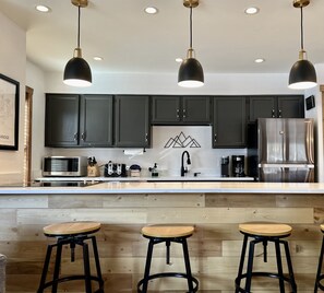 Newly refinished kitchen with quartz counters seating for 4 