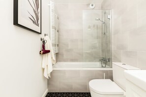 Bathroom  with bathtub, toilet, sink and mirror