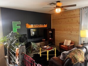 Renovated living room with the reclining leather sofa and tons of dvds to watch!