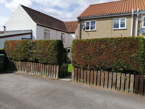 Rear of property with parking spaces for 2 cars