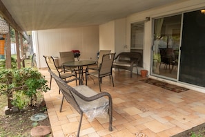 The cover patio holds 8 people 4 on the table and 4 on the benches.