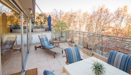 Wonderful morning terrace with Soho treetop view. Washer/dryer is in cabinet