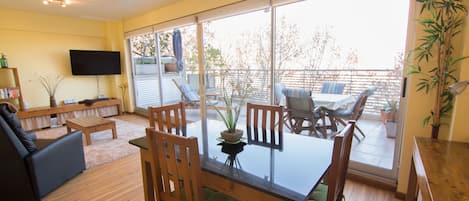 Smart TV, new flooring, glass wall open to terrace; and dimmer lighting