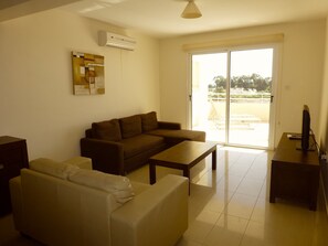 Living area with patio door leading to balcony.