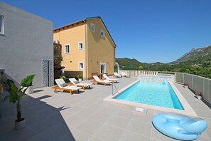 Playground, sun deck area, and in grey part of house is a pool table and sauna