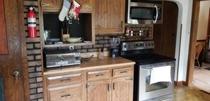 Kitchen area with stainless steel appliances -Basic cooking necessities supplied