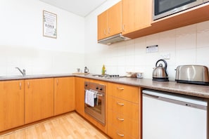Kitchen - Crockery & cutlery provided along with basic kitchen amenities.
